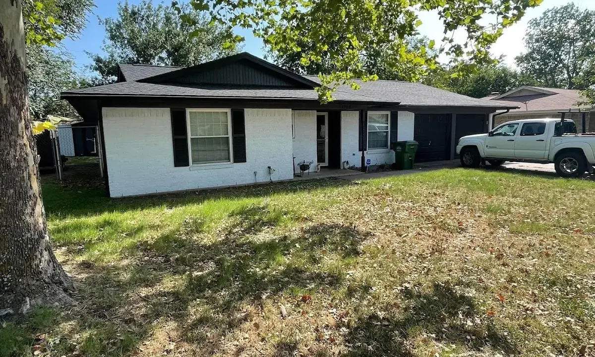 Professional roofing crew working on a residential roof in Wallington